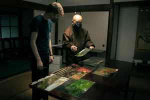 The Shouhouji Abbot shows Alex various papers and effects relating to the temple, including photographs of the scenery at different seasons